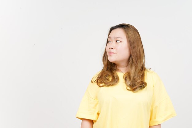 Smile and Looking away of Beautiful Asian Woman wearing yellow TShirt Isolated On White Background