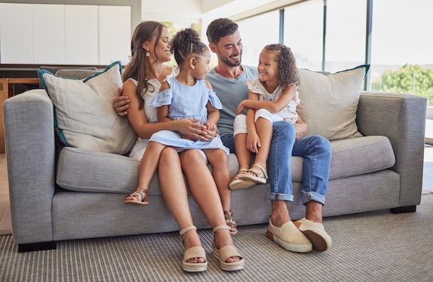 Smile love and happy family love to relax together in a positive home on a fun weekend for bonding Happiness mother and father smiling with young Latino kids or children enjoying quality time