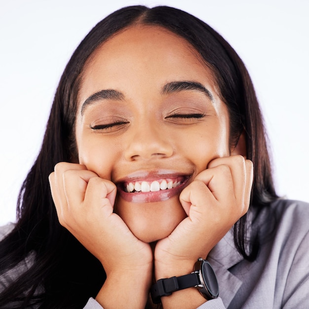 Smile shy and hands on face of woman in studio for self love thinking and memory against white background Happiness emoji and female with fingers on cheeks for goofy expression or happy gesture