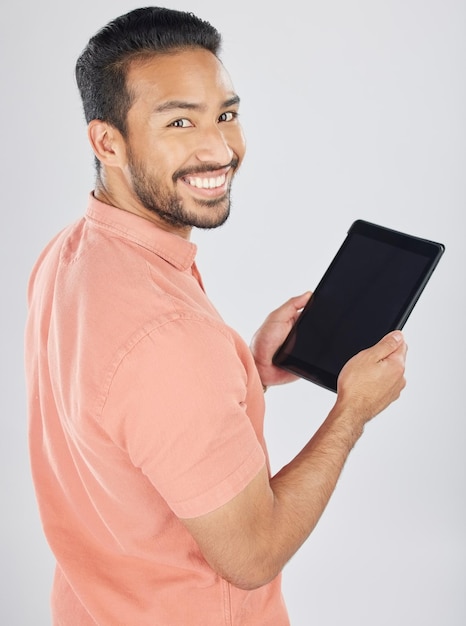 Smile tablet and portrait of man search internet with technology isolated in a studio white background Online planning and young person or student working on connection or networking on app