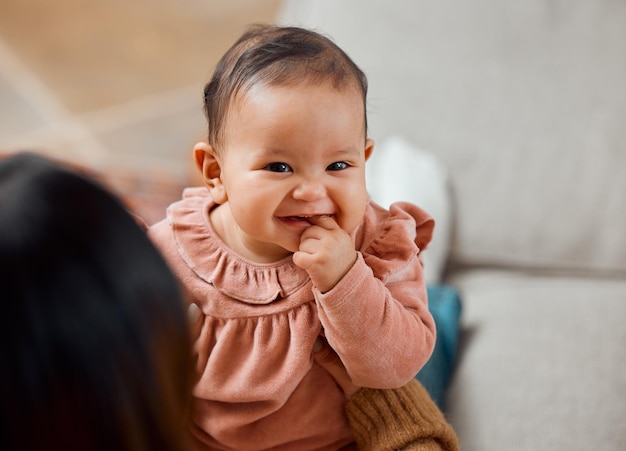 A smile thatll melt hearts Shot of a woman bonding with her baby while sitting at home