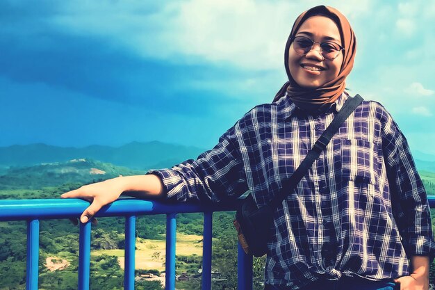 The smile of a woman among the natural scenery