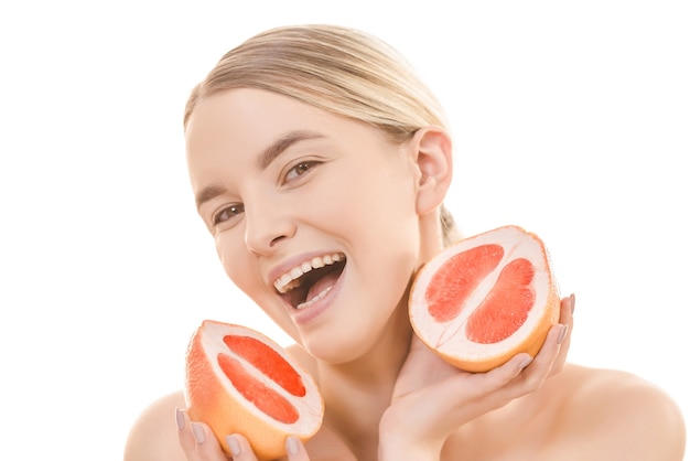 The smile woman holding a grapefruit on the white background