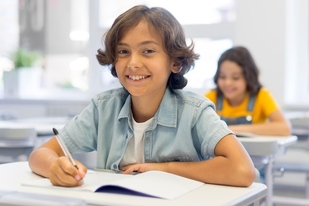 Photo smiley boy writing