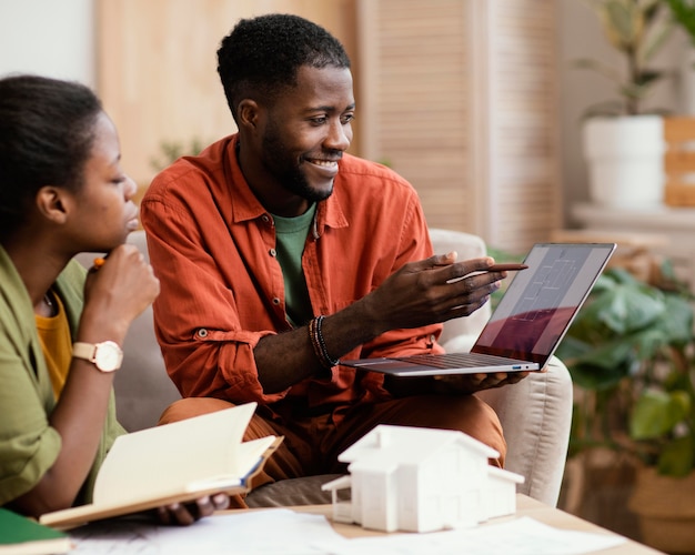 Smiley couple making plans for renovating home