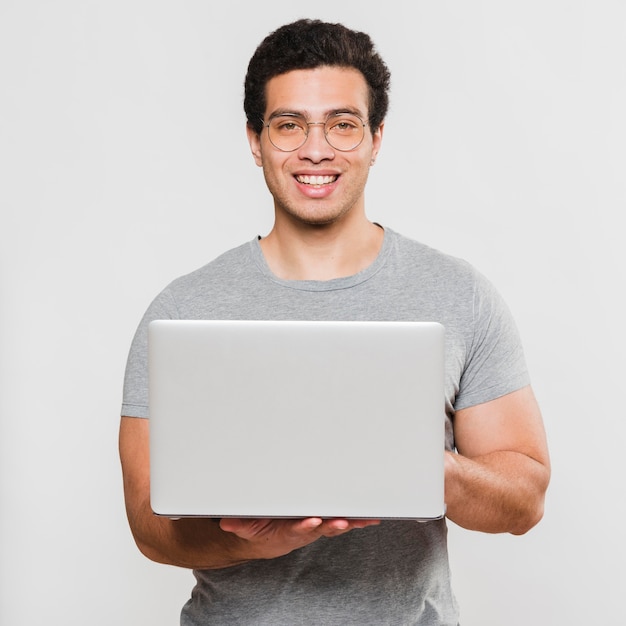 Smiley fit student holding laptop