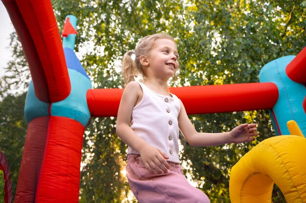 Smiley girl in bounce house side view