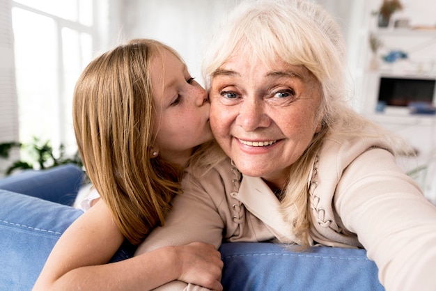 Smiley girl kissing grandma