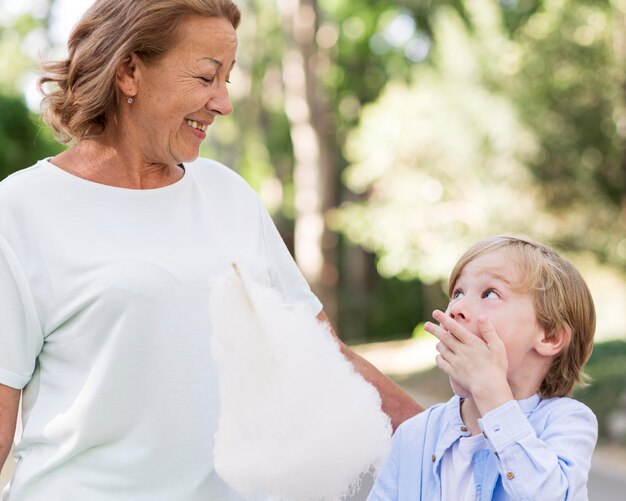 Smiley grandma and kid with cotton candy