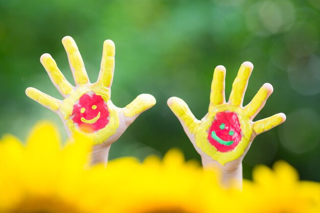 Smiley hands against green spring background