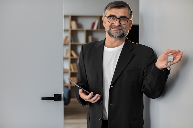 Smiley host holding keys front view