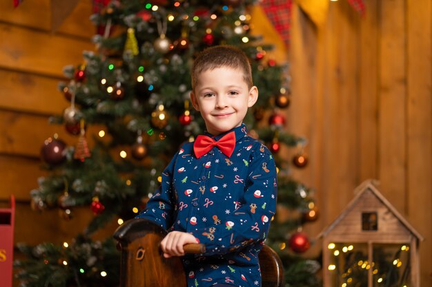 Smiley little boy on rocking chair for Christmas