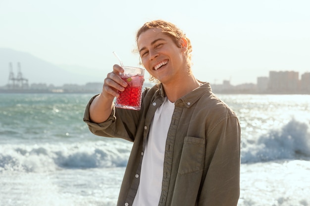 Smiley man holding sangria medium shot