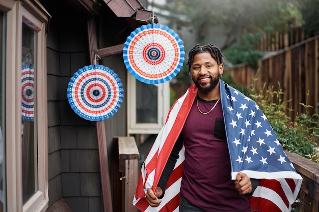 smiley man with flag outdoors medium shot
