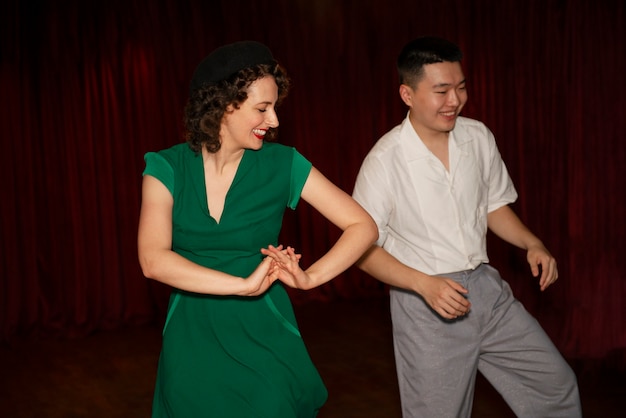 Photo smiley partners swing dancing medium shot