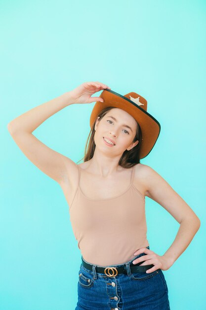 Smiley portrait of beautiful woman with a cowboy hat shoot in studio