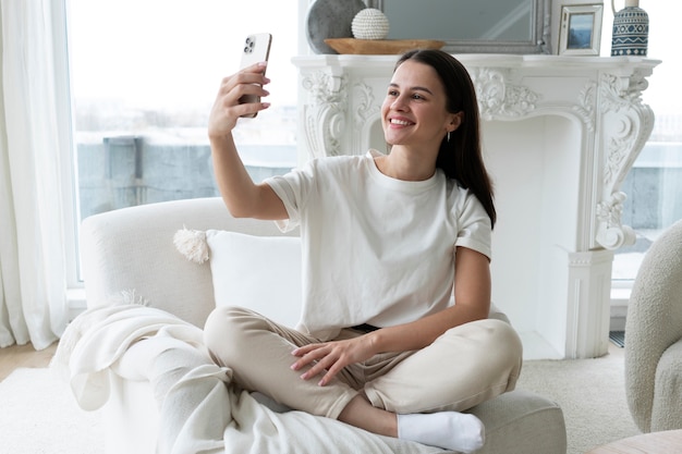 Photo smiley woman taking selfie full shot