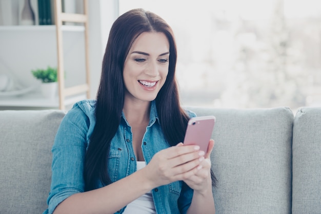 Smiley woman using smartphone