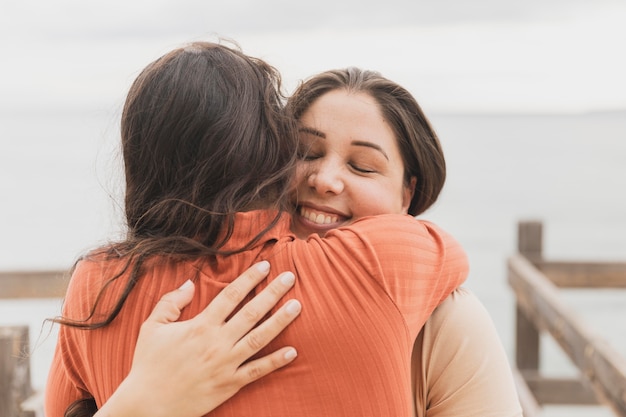 smiley women hugging