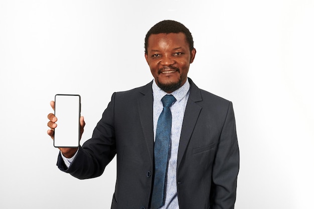 Smiling african american black man in business suit with smartphone mockup in hand white background