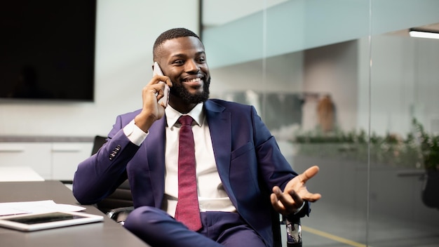 Smiling african american boss having phone conversation