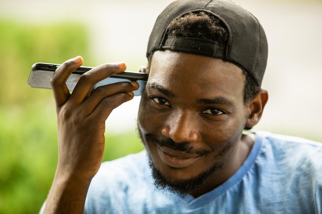 Photo smiling african american man listening audio message