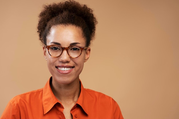 Smiling African American student wearing stylish eyeglasses isolated on background, education