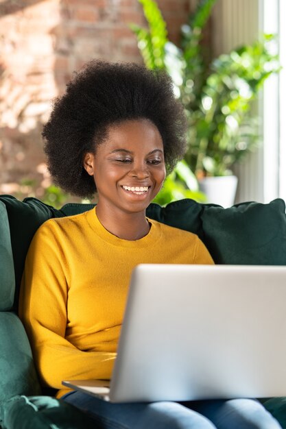 Smiling African American woman remote work on laptop