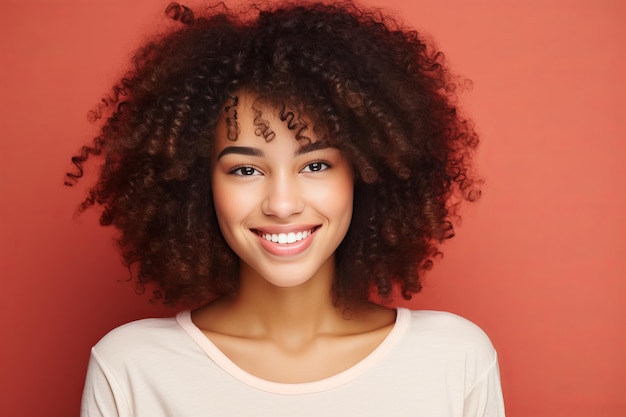 Smiling african american woman in white mock up tshirt posed against vibrant solid background