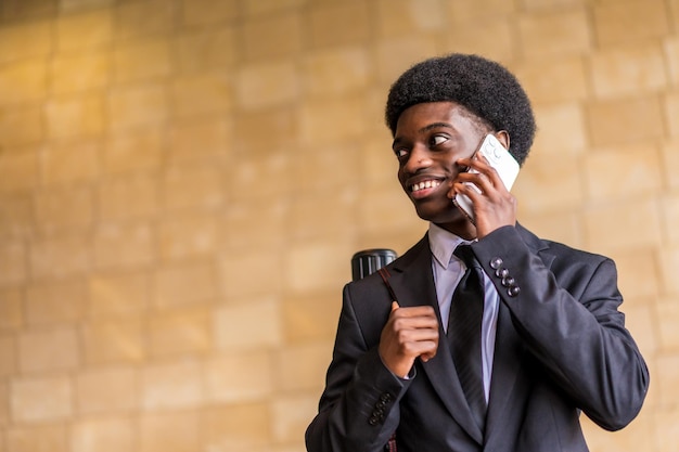 Smiling african architect talking to the mobile phone