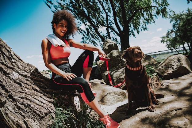 Smiling African Girl with Dog Outdoors