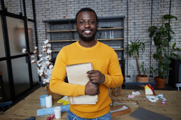 Smiling African Man Posing in Art and Craft Studio