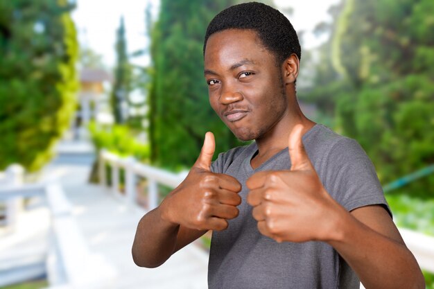 Smiling african young man showing thumbs up