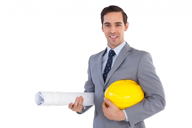 Smiling architect holding plans and hard hat