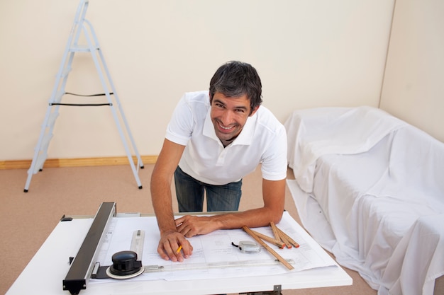 Smiling architect man decorating a bedroom