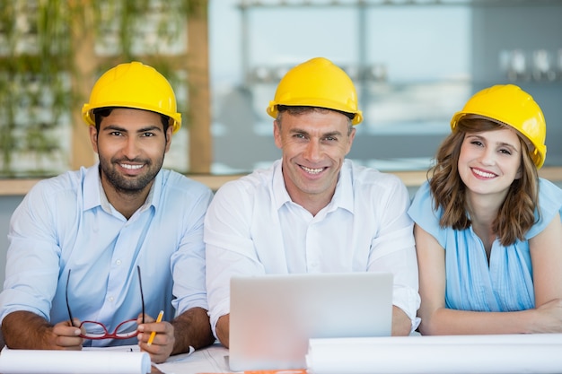 Smiling architects sitting together in conference room