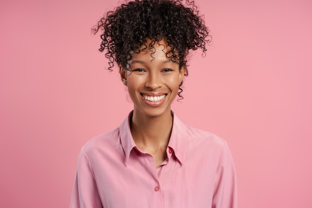 smiling arfican american woman wearing shirt looking at camera standing isolated