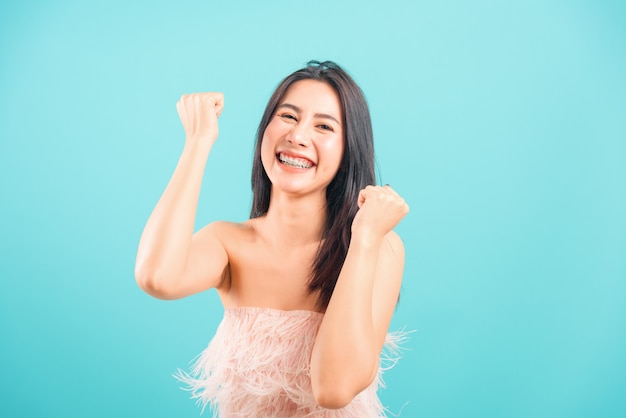 Smiling asian beautiful woman celebrating success