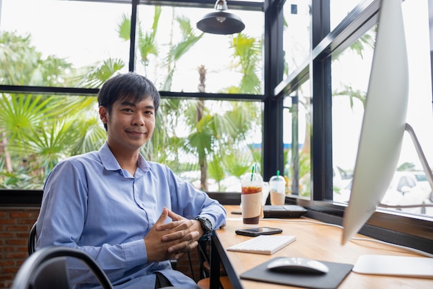 smiling asian businessman in coffee shop