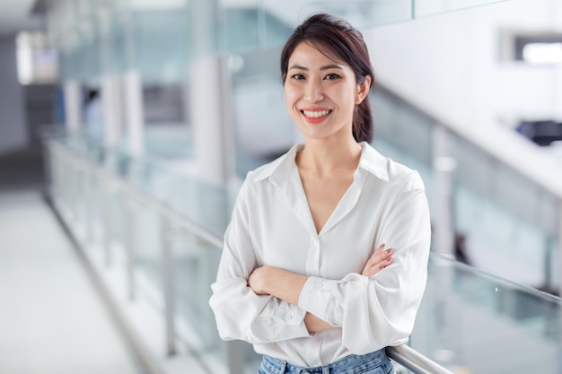 Smiling Asian businesswoman on blur office building background