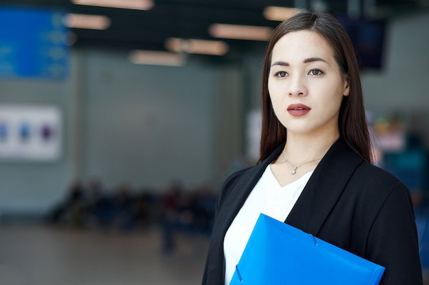 Smiling asian businesswoman in modern office or meeting room