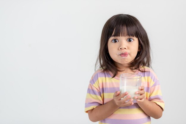 Smiling of Asian girl with a glass of milk