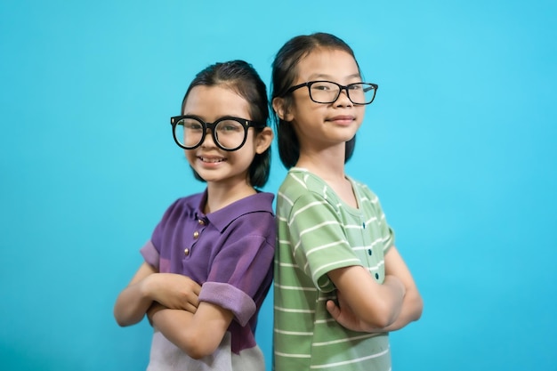 Smiling Asian kids girl photo of cute and cheerful people, wearing glasses looking and smile