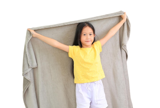 Smiling asian little child girl cover head with gray blanket isolated on white background winter season concept