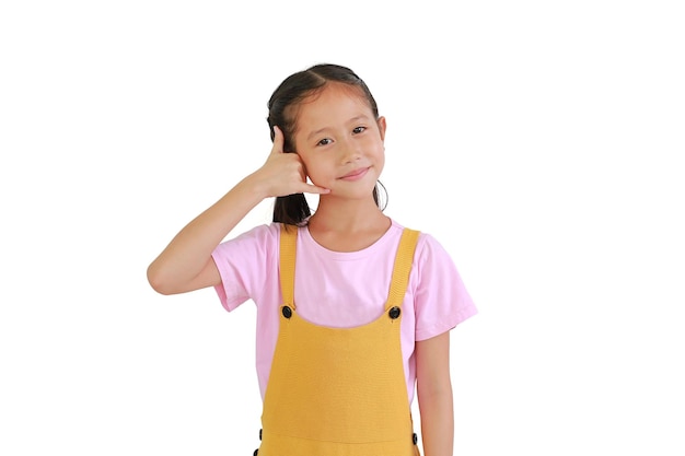 Smiling Asian little girl child making phone gesture isolated on white background Call me back sign