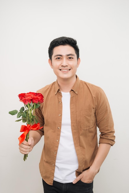 Smiling Asian man holding bunch of roses