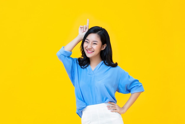 Smiling Asian woman standing in studio 