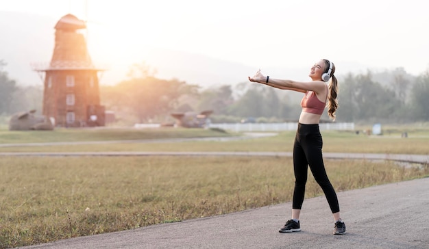 Smiling Asian Young fitness sport woman exercising and Sportive people training outdoors healthy lifestyle and sport concepts