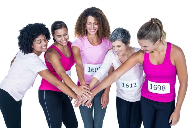 Smiling athletes putting their hands together 