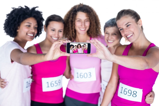 Photo smiling athletes taking self portrait with smartphone